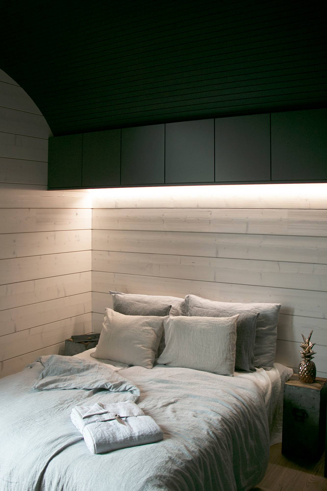 Encima de la cama, en la esquina de los armarios y la pared, una tira de LED como luz de ambiente. Ledstore.fi